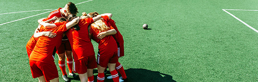 soccer team in a huddle