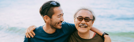father and son walking on beach