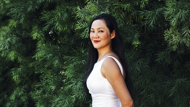 Woman against a backdrop of leaves 