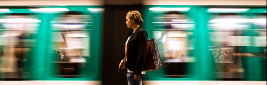 A person strides in front of a train, representing the retirement journey and the importance of using custom or investable benchmarks.