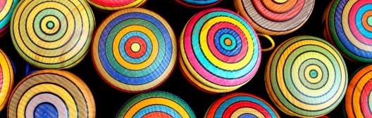 An array of colorfully painted wooden yoyos