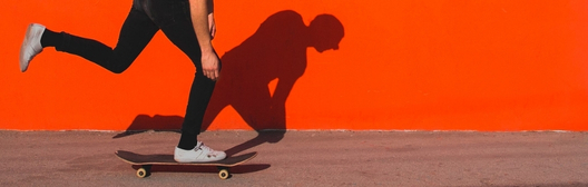 Man riding skateboard on street.