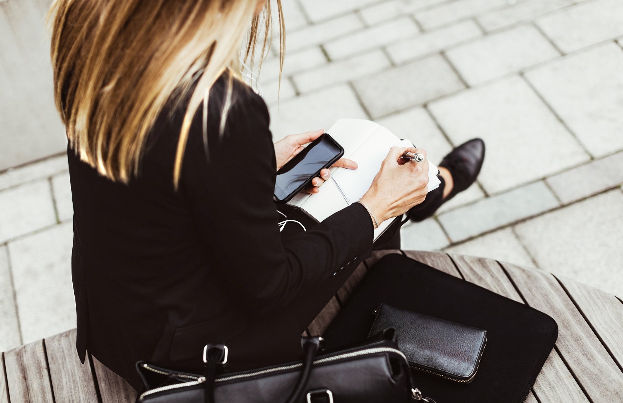 Image of woman with notebook and phone.