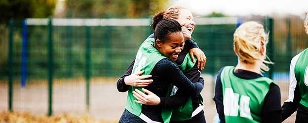 Image of youth athletes celebrating after a win.