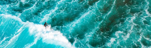 big wave in ocean with surfer