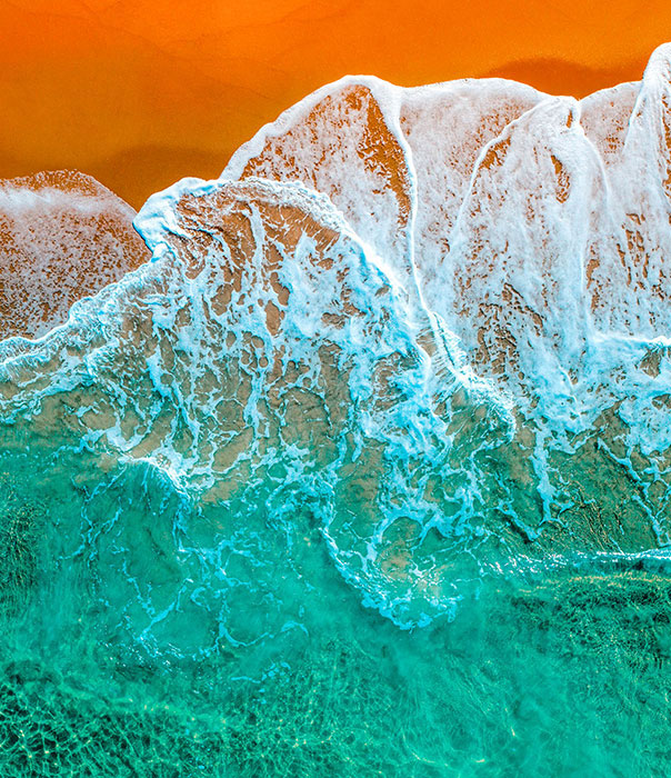 wave on the beach comes through