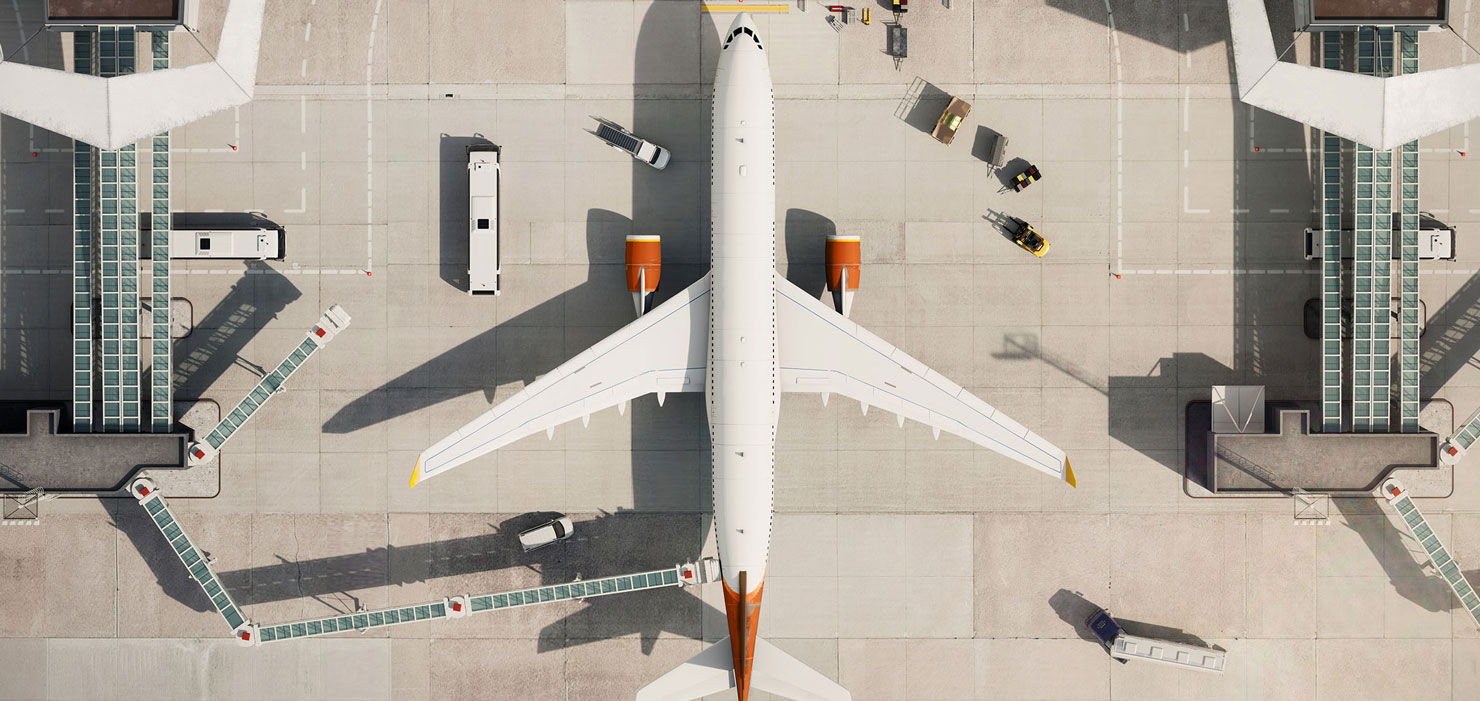 Aerial view of a commercial airplane at airport gate.