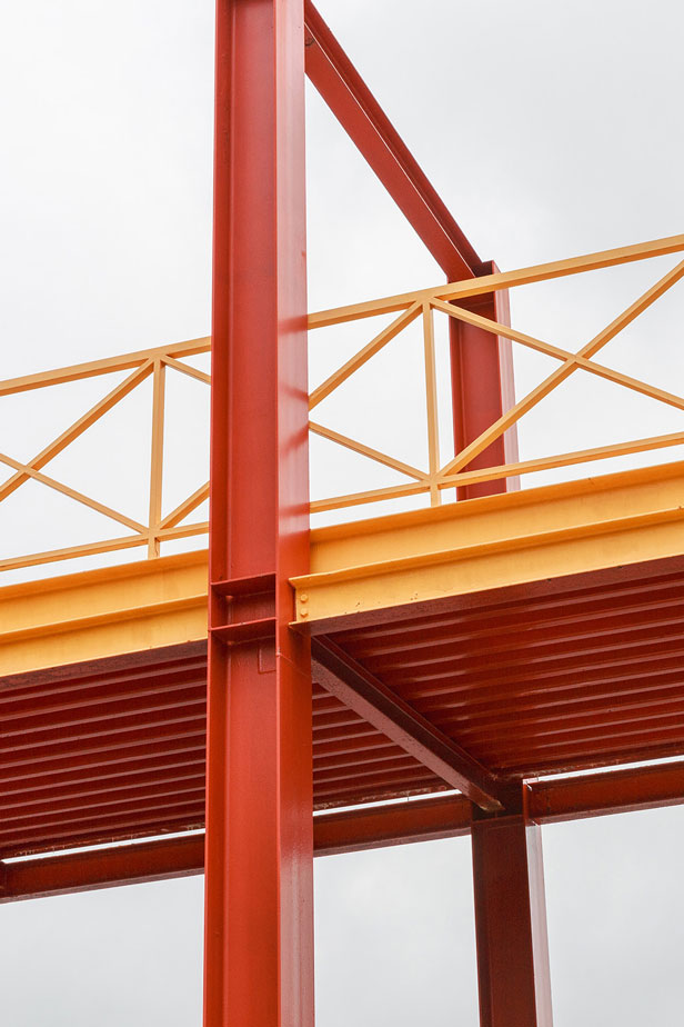 Close-up of a steel bridge painted in yellow and red.