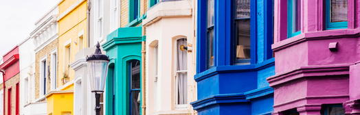 A row of different colored homes. 