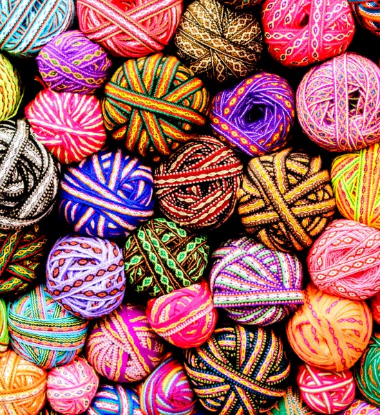 Brightly colored patterned yarn balls arranged together represeting updated models an gradual reduction in risk