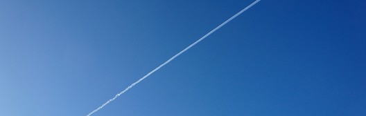 Airplane contrail against a blue sky representing deleveraging a tax-managed long/short portfolio.