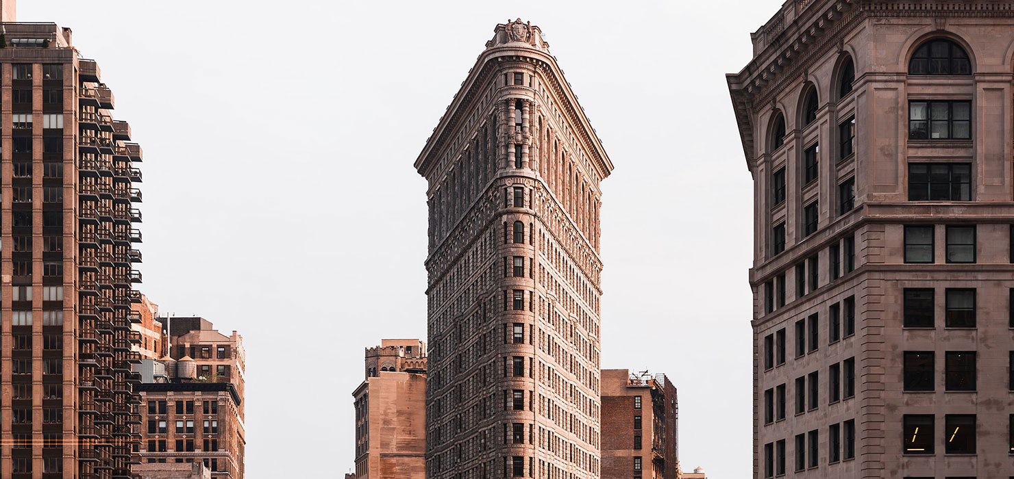 The Flatiron Building in New York City surrounded by other tall buildings