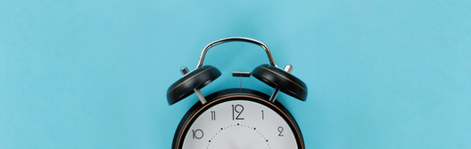 Alarm clock against a blue background