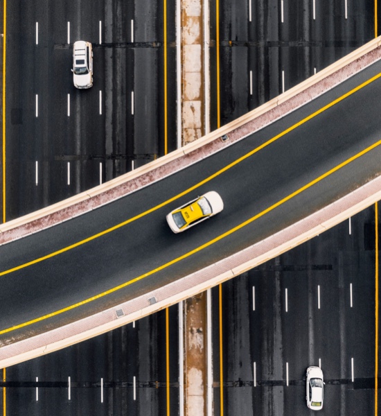 A bird's eye view of vehicles driving through an interstate exchange
