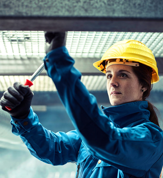 A female worker in protective work clothing.
