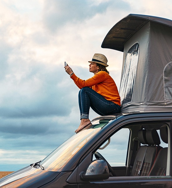 Woman sitting on car