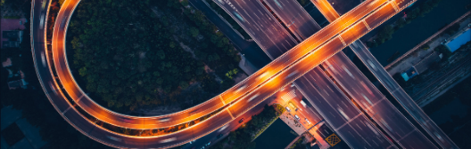 A lit up road with a bend