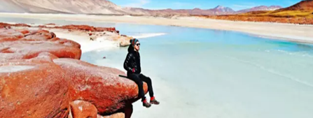 A person sitting on a rock