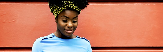 Lady on phone in front of a wall