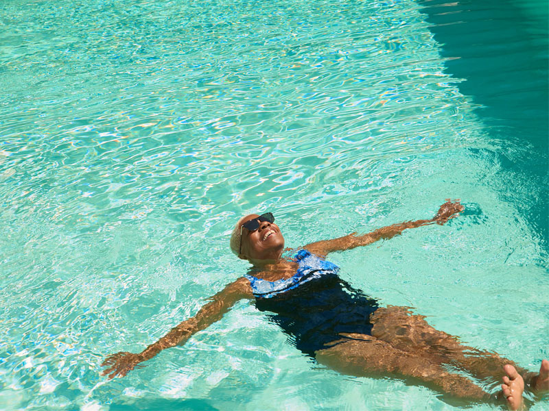 Woman floating in a swimming pool.