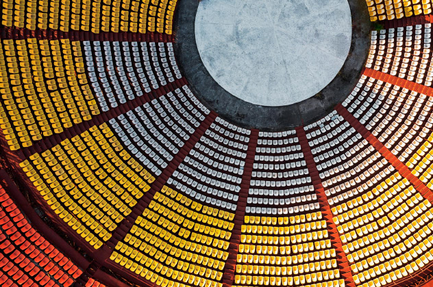 An interior view of a circular space featuring many chairs
