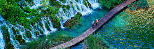 People crossing river on bridge
