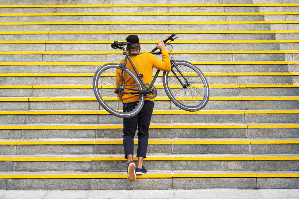 Man with bicycle climbing stairs