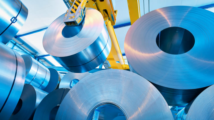 Rolls of steel sheets hanging in a factory