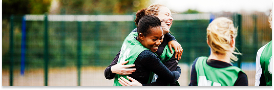 Image of a sports team hugging.