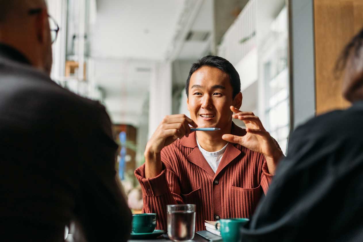 Man talking to two persons