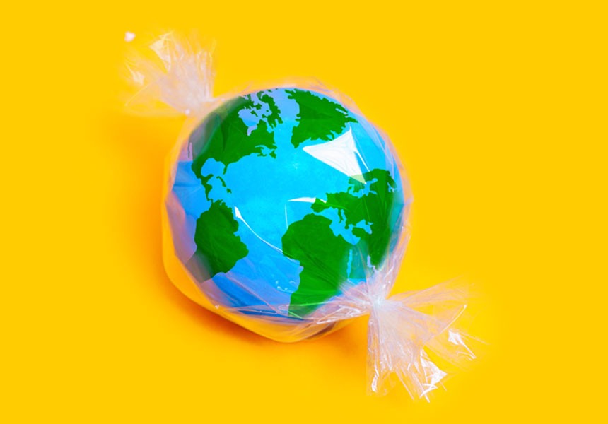 a miniature globe model wrapped in plastic