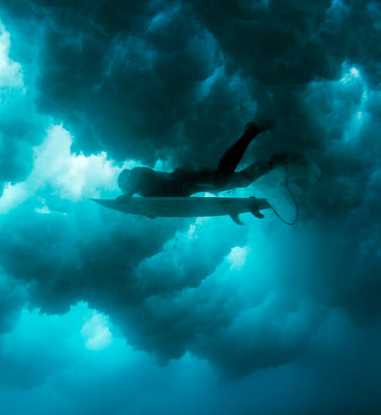 Surfer under cloudy water