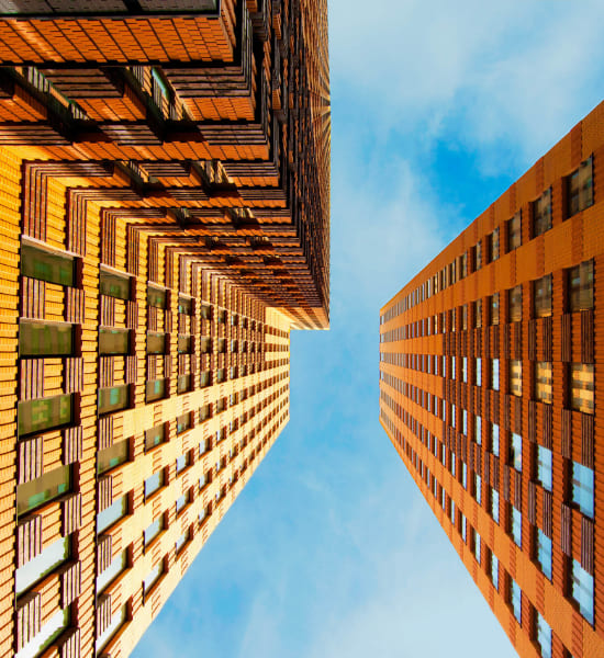 Looking up at tall brick buildings