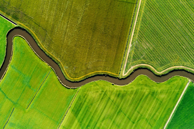 River meandering through grass fields