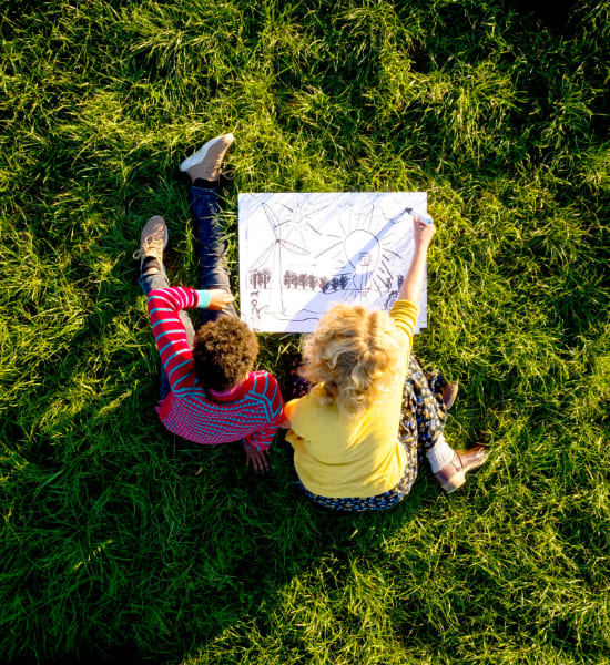 Two children drawing in the garden