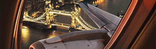 View from plane into central London showing lit up London Brdige