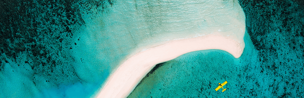 plane hovering over sea