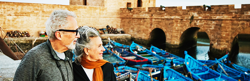 Elderly couple look out over harbour