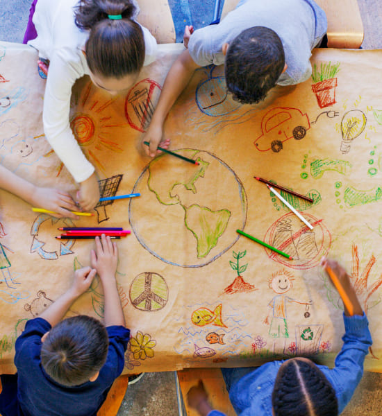 Children drawing using crayons