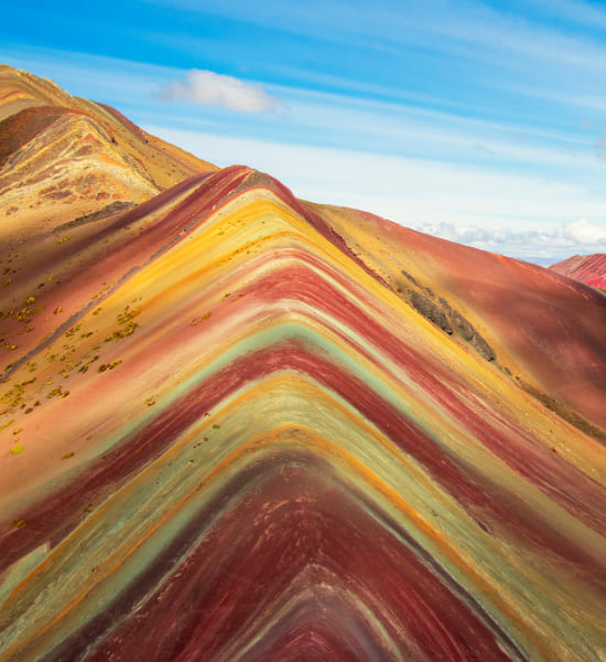 Multi-coloured sand dunes across a desert