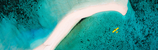 plane hovering over sea