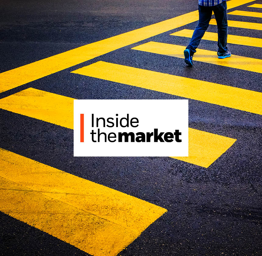 A man is walking across a crosswalk.