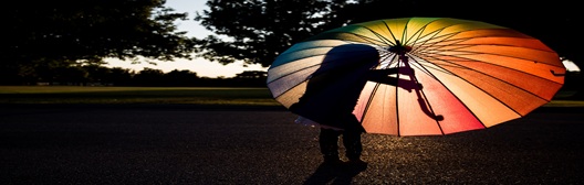 Image shows someone holding an umbrella