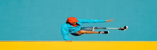 Image shows man jumping over wall