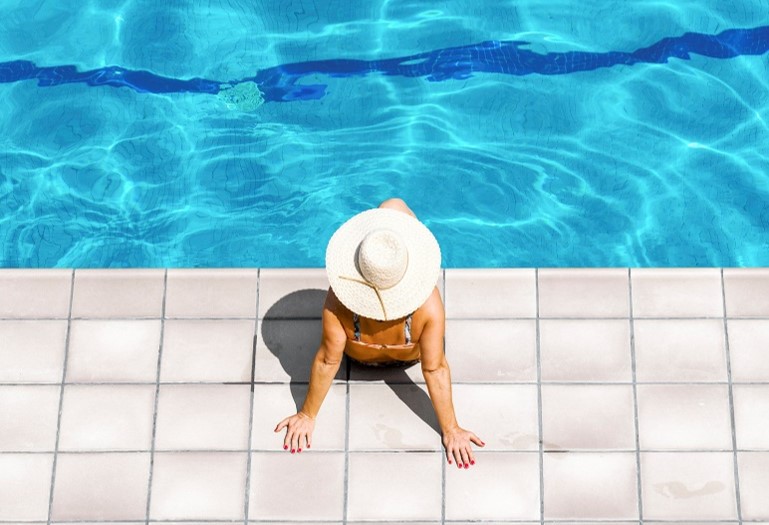 women sitting by pool