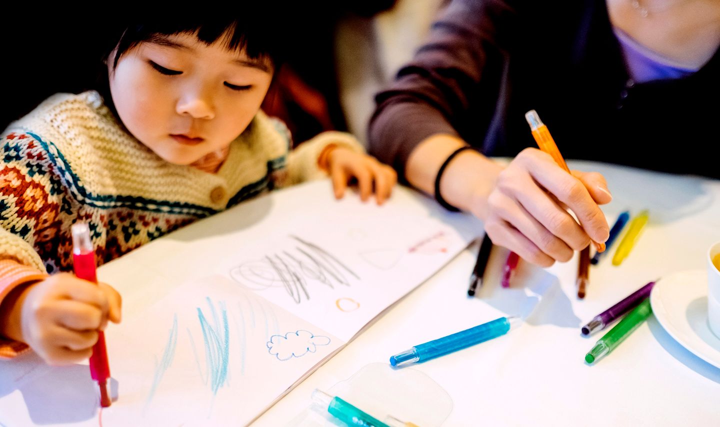 Girl coloring the book