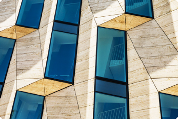 Colorful glass skyscrapers with vertical patterned fa�ades.