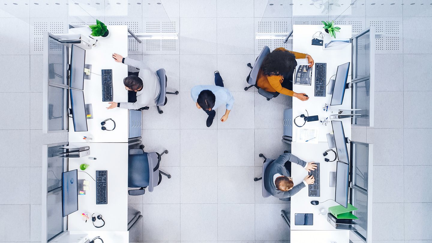 Top Down Shot of Big Busy Corporate Office with Two Rows off Businessmen and Businesswomen Working on Desktop Computers. Director is Walking Between Rows. Open Space Office with Businesspeople