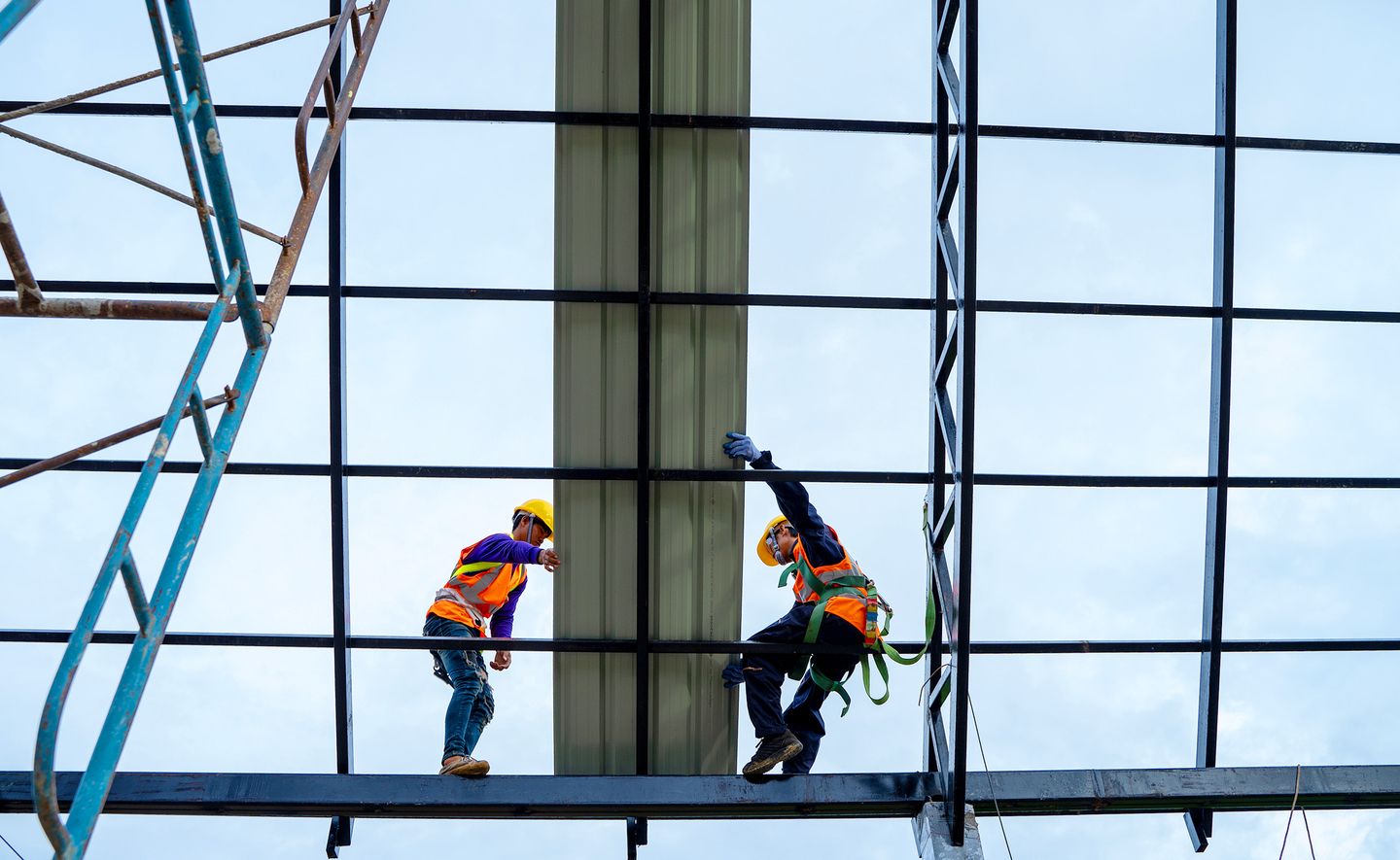 Two construction workers on building.