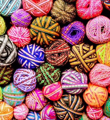 Brightly colored patterned yarn balls arranged together represeting updated models an gradual reduction in risk